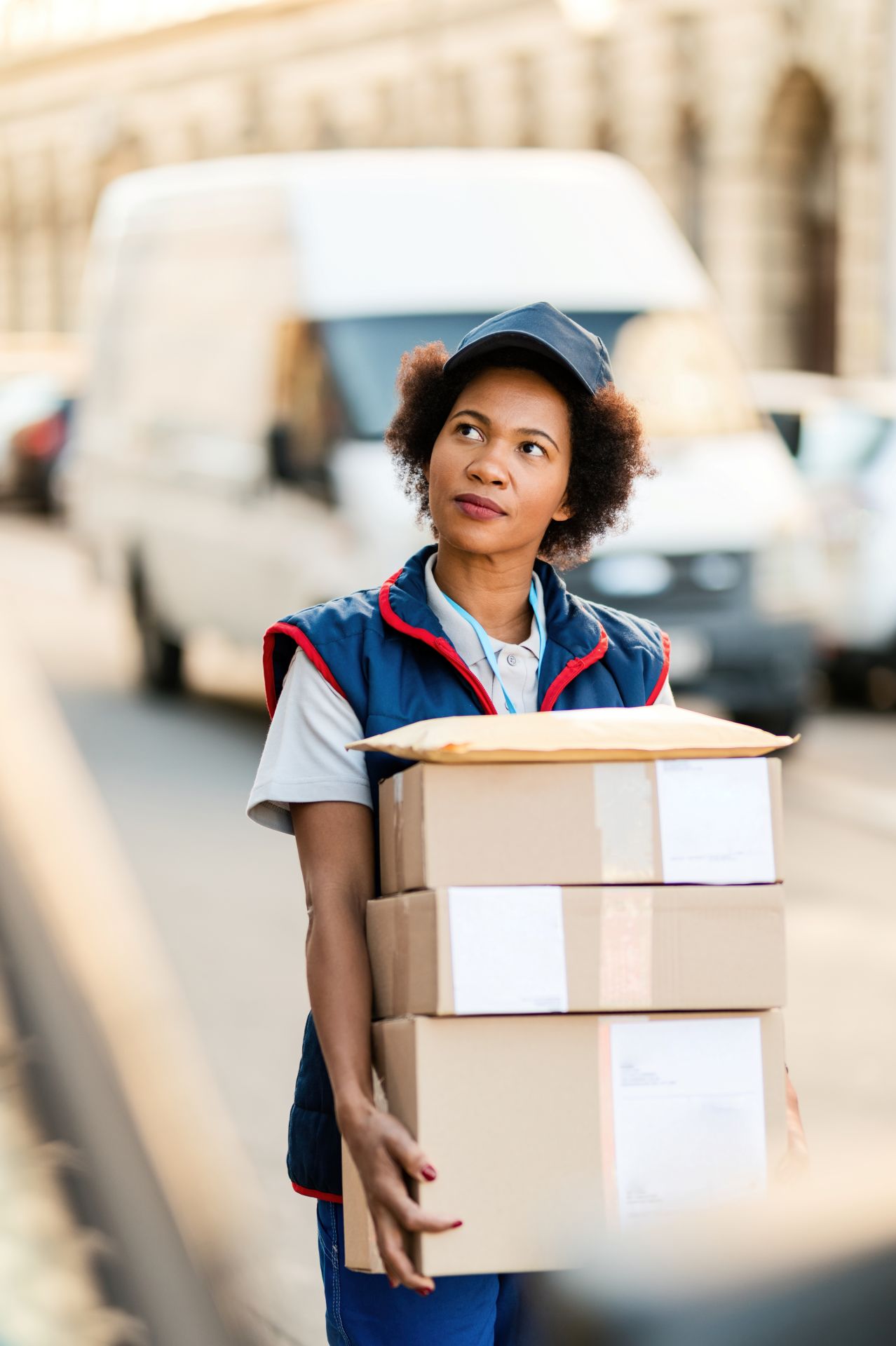 black-female-courier-carrying-packages-while-makin-2024-12-13-19-37-43-utc.jpg